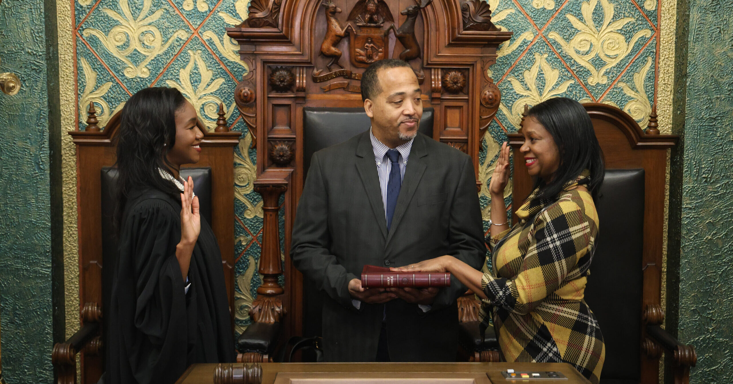 Michigan State Representative Tonya Myers Phillips standing with a guest while being ceremoniously sworn into the 103rd Legislature by Michigan Supreme Court Justice Kyra Harris Bolden.