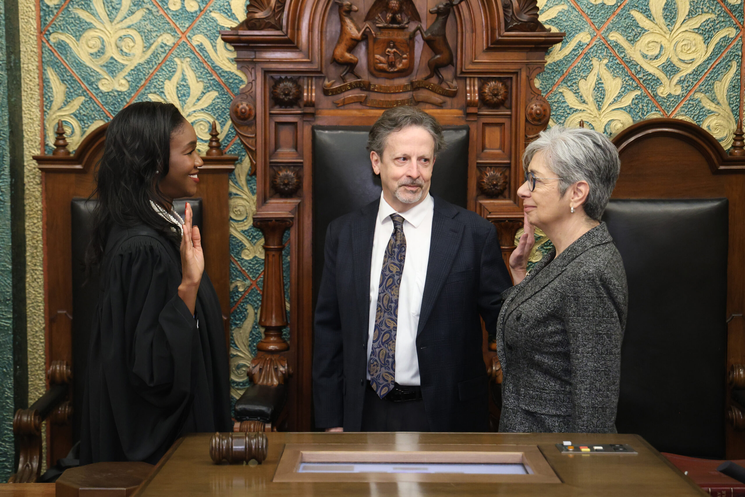 Michigan State Representative Veronica Paiz takes the oath of office from Michigan State Supreme Court Justice Kyra Harris Bolden with her husband by her side.