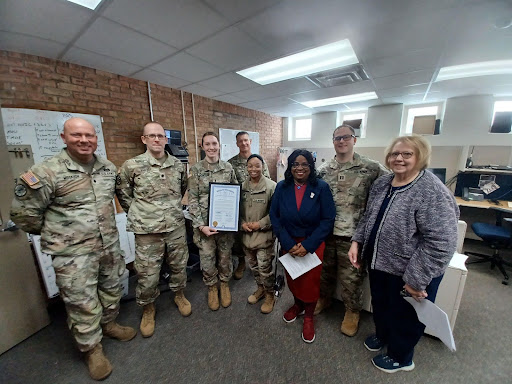 State Rep. Brenda Carter  standing with members of the Michigan National Guard’s 1775th Military Police Company.