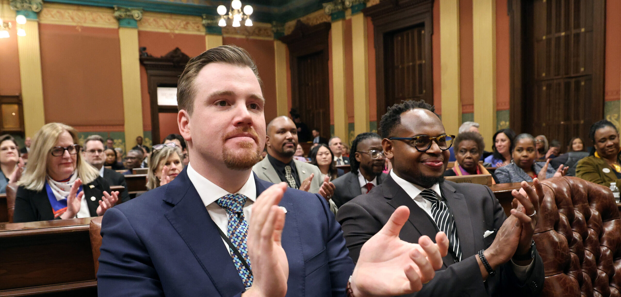 Democratic Floor Leader John Fitzgerald and Pastor Parris McMurray applauding at the State of the State Address on the House floor.