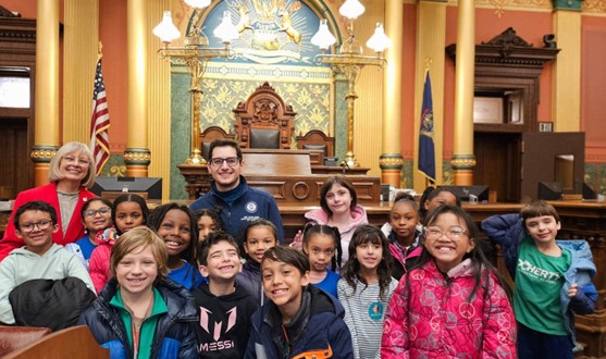 Michigan State Representative Noah Arbit and Michigan State Senator Rosemary Bayer posing for a photo with 3rd Graders from Doherty Elementary.