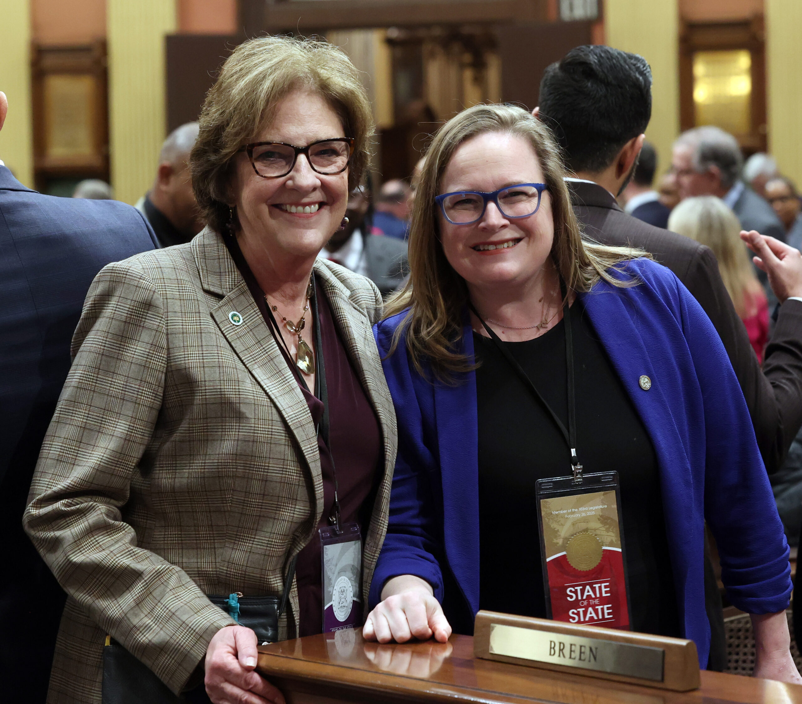 Rep. Kelly Breen stands with her guest, Gwen Markham, County Commissioner, on the floor of the Michigan House of Representatives in the Michigan Capitol in Lansing on February 26, 2025.