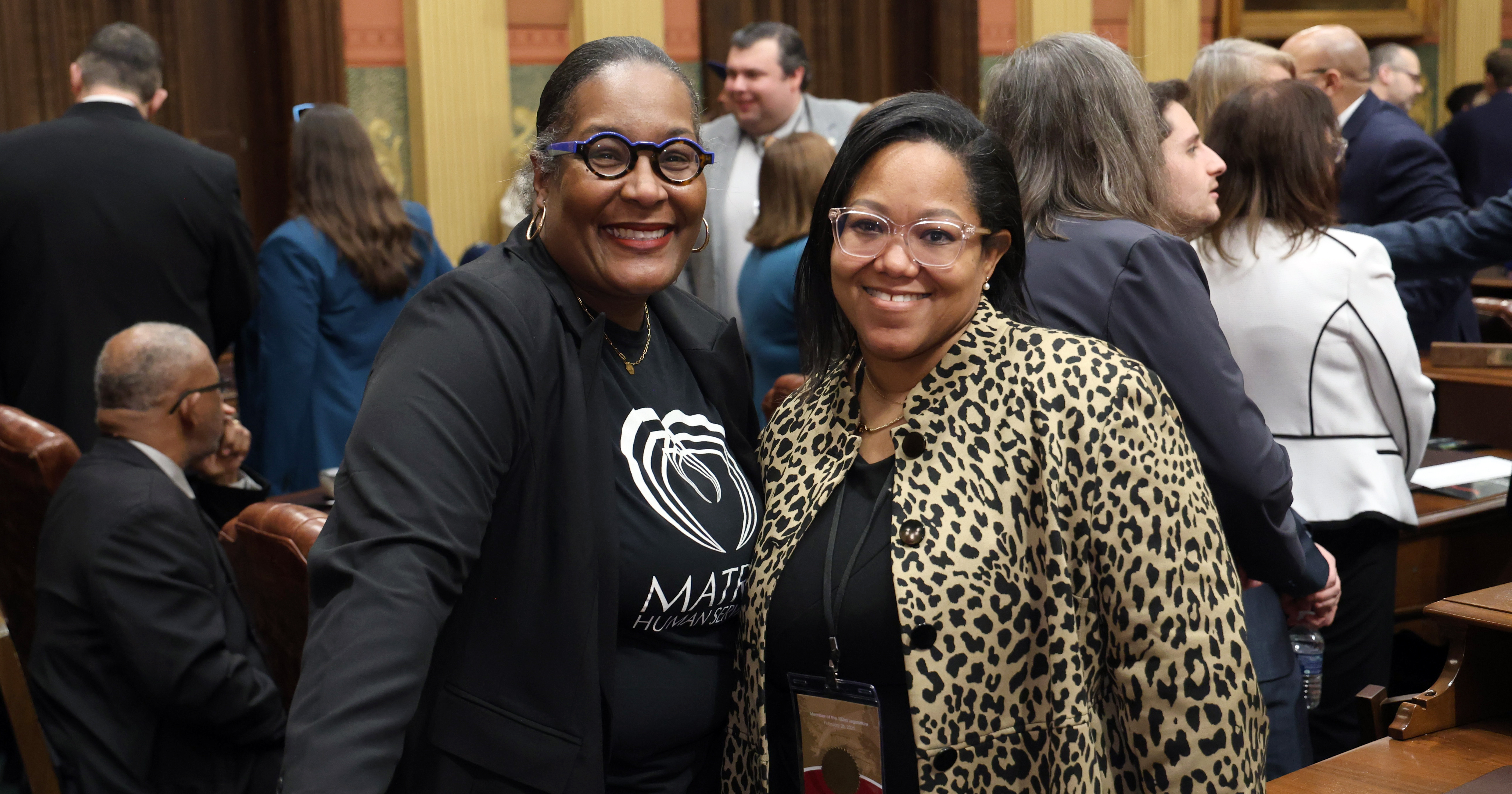 Rep. Kimberly Edwards stands with her guest, Kenneth Nixon, on the floor of the Michigan House of Representatives in the Michigan Capitol in Lansing on February 26, 2025.