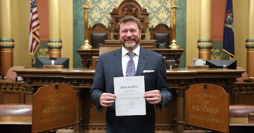 Michigan State Representative Doctor Matt Longjohn holds his signed oath of office on the House floor.