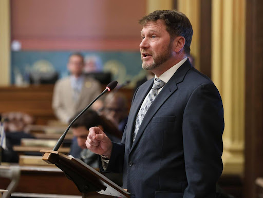 Image of Michigan state Rep. Dr. Matt Longjohn speaking on the house floor.