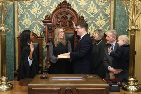 Michigan State Representative Stephen Wooden is ceremoniously sworn in by Michigan Supreme Court Justice Kyra Harris Bolden.