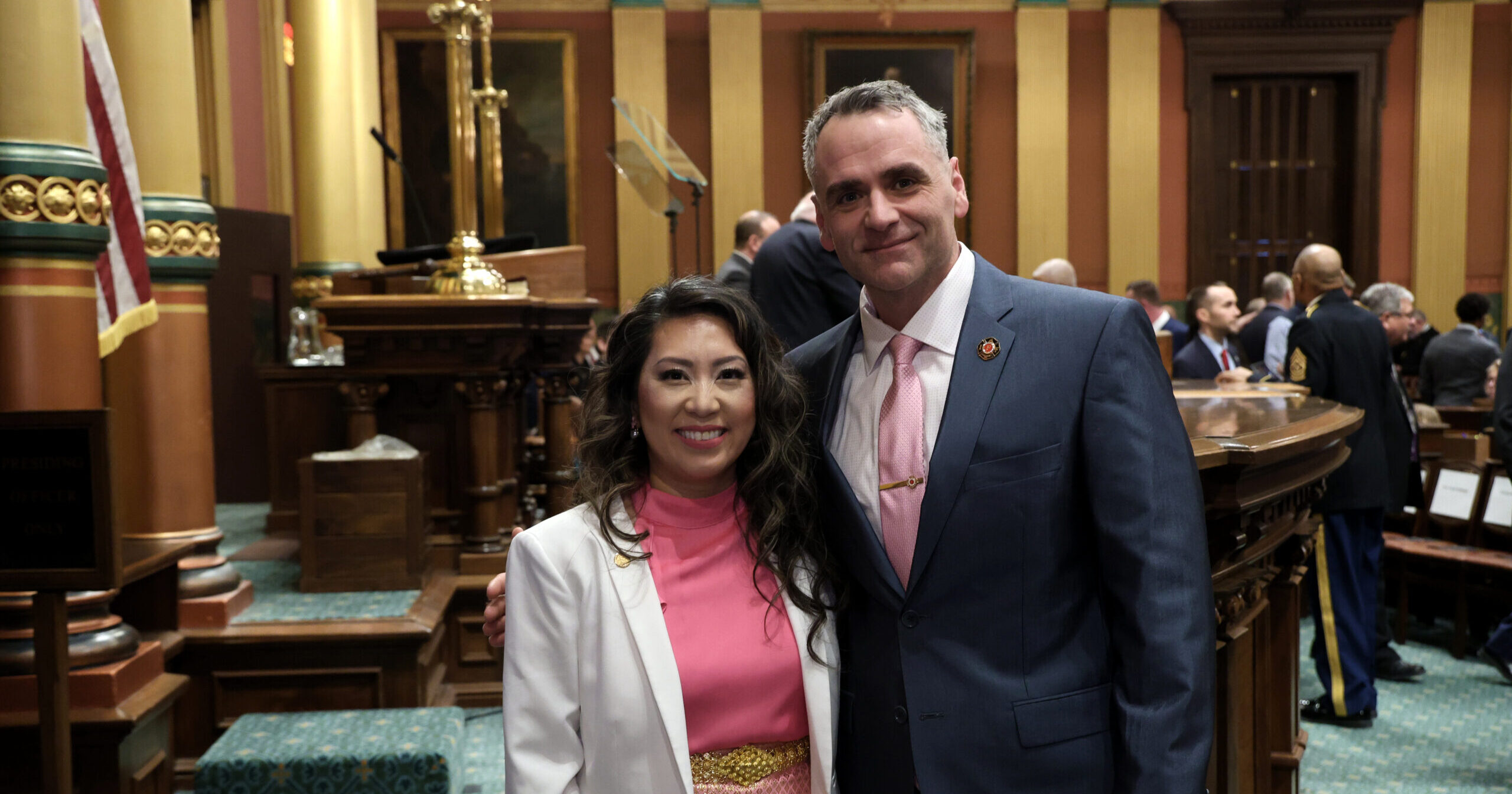 State Representative Mai Xiong and President of the Michigan Professional Firefighters Union Matthew Sahr standing together for a photo on the House floor.