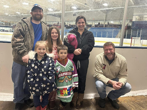 Image of a Hockey family and State Rep. Longjohn from his community.