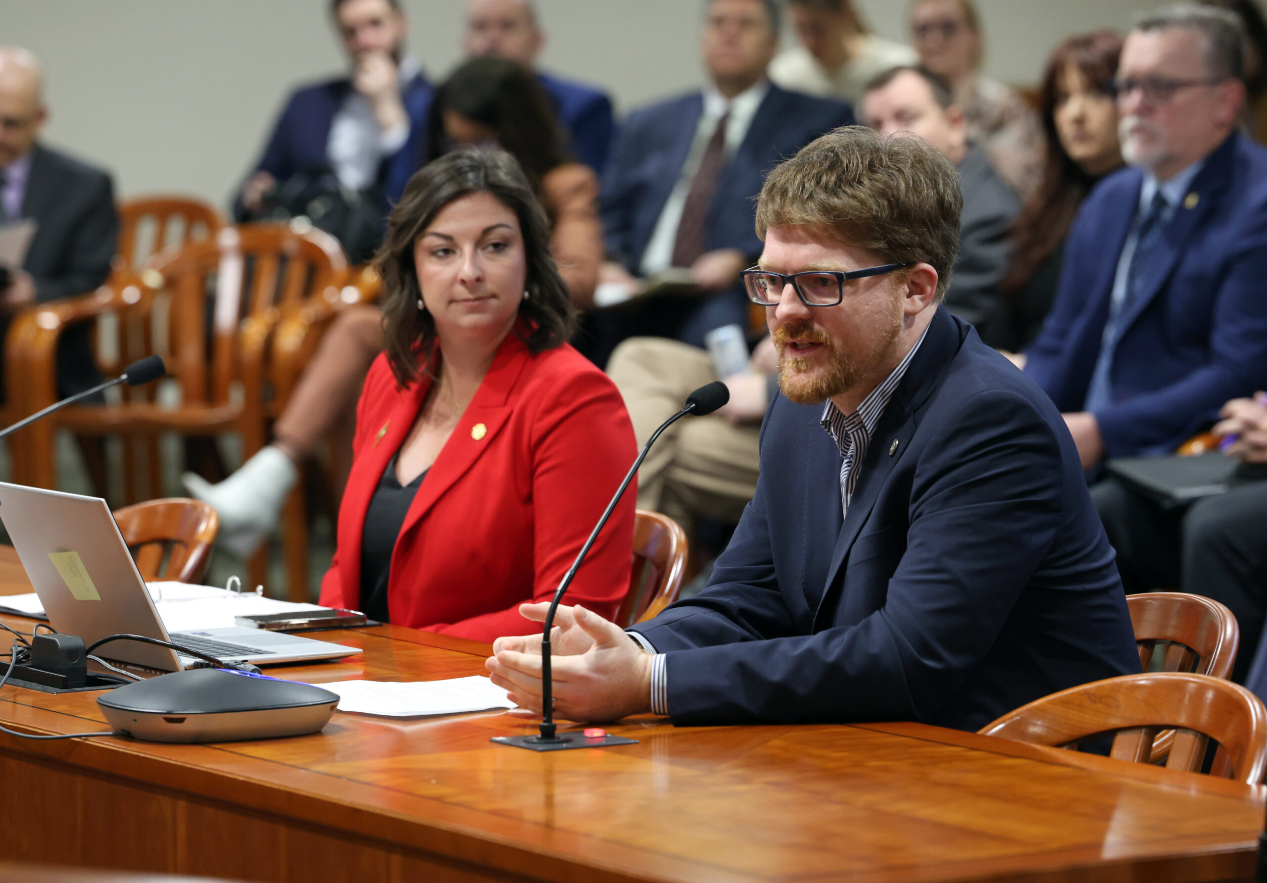 Michigan State Representatives Joey Andrews and Pauline Wendzel testify in a Houe committee.