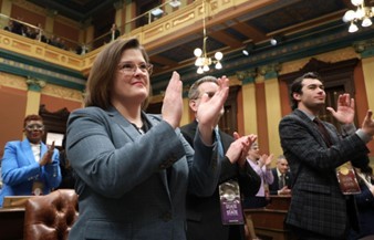 Michigan State Representative Kara Hope claps at the State of the State Address.