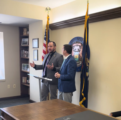 Michigan State Representatives Dylan Wegela and Steve Carra speak at a press conference.