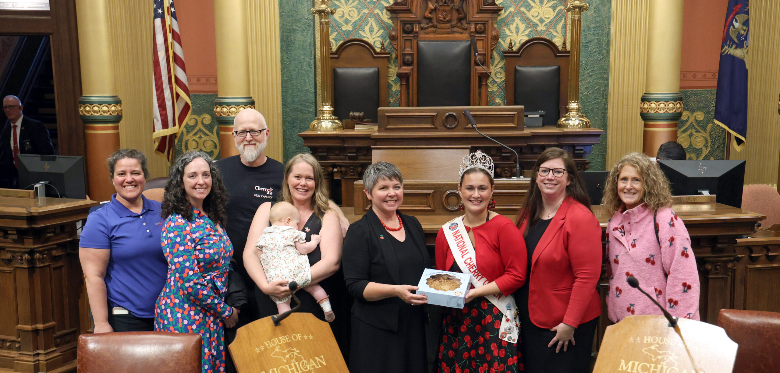 State Rep. Betsy Coffia (D-Traverse City), center left, welcomes 2024-25 National Cherry Queen Tessa Nico, center right, on May 21, 2025, at the Michigan Capitol Building in Lansing.
