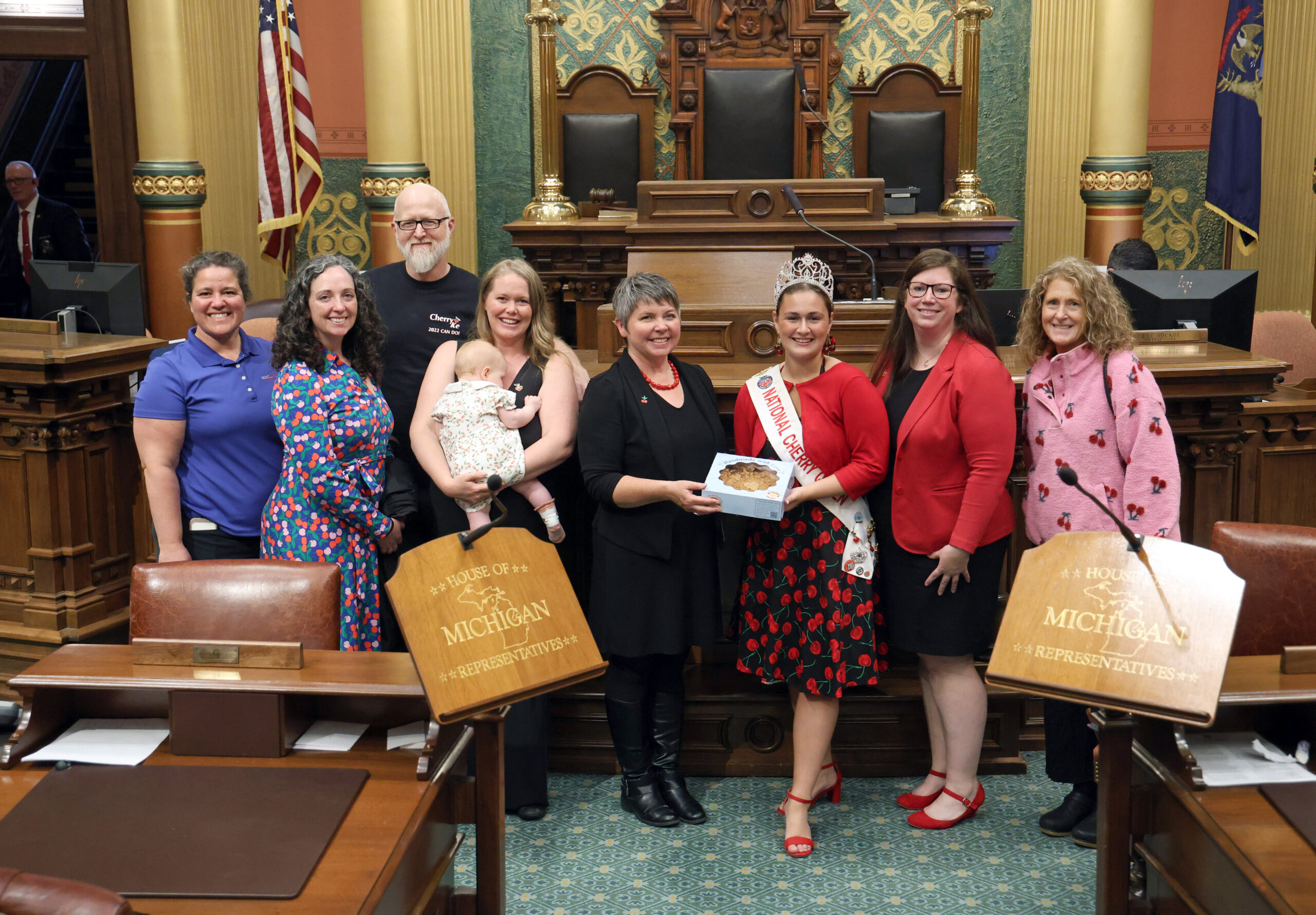 State Rep. Betsy Coffia (D-Traverse City), center left, welcomes 2024-25 National Cherry Queen Tessa Nico, center right, on May 21, 2025, at the Michigan Capitol Building in Lansing.