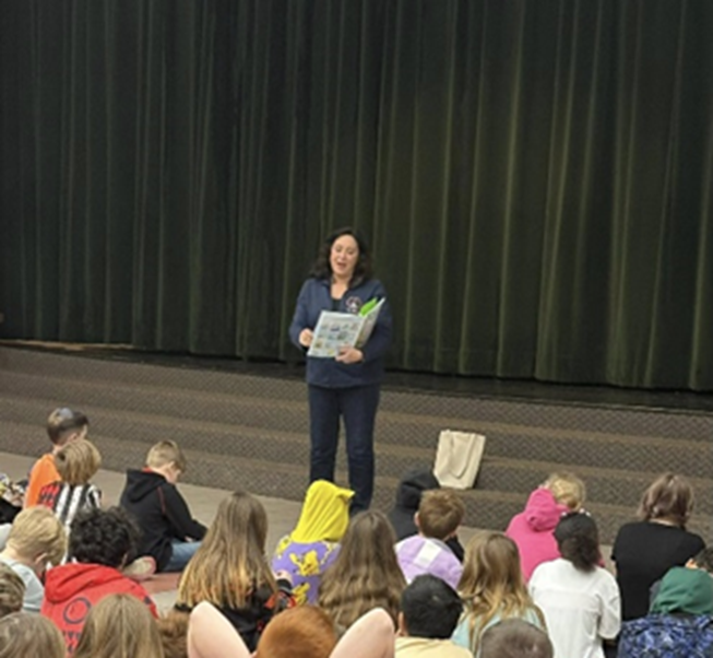 Michigan State Representative Angela Witwer reading to a class of elementary students.