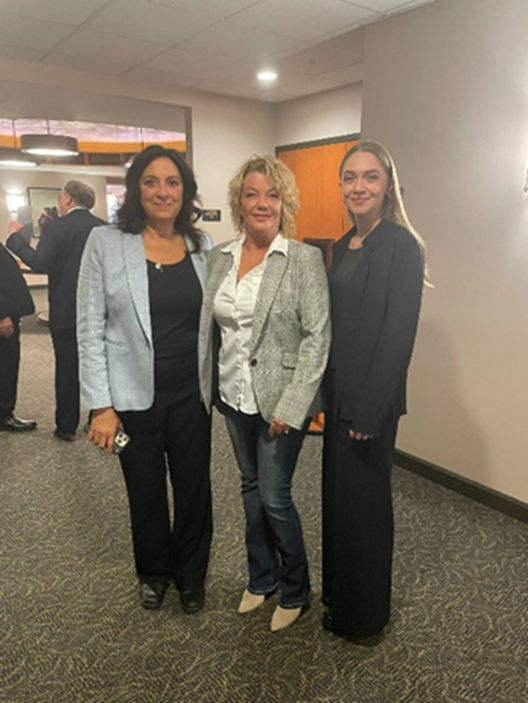 Michigan state Representative Angela Witwer posing for a photo with Missy and Savannah Smith in the Anderson House Office Building.