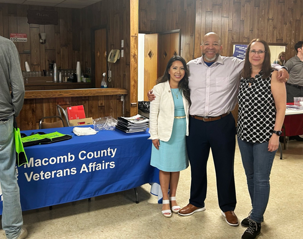 Michigan state Representative Mai Xiong posing for a photo with community members at her Veterans Resource Fair.