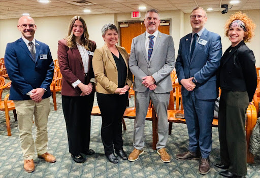 State Rep. Betsy Coffia, center left, with Northern Michigan Chamber Alliance officials, including Haley Bennett of Traverse Connect and Northern Michigan Regional Chamber Alliance chair Nikki Devitt, following the group’s testimony in the House Economic Competitiveness Committee, on which state Rep. Coffia serves. Group is pictured with committee chair state Rep. Mike Hoadley.