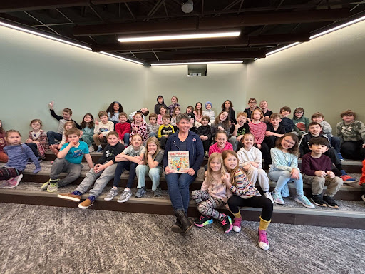 State Rep. Betsy Coffia, center, reading to elementary students at TCAPS Montessori for March Is Reading Month.