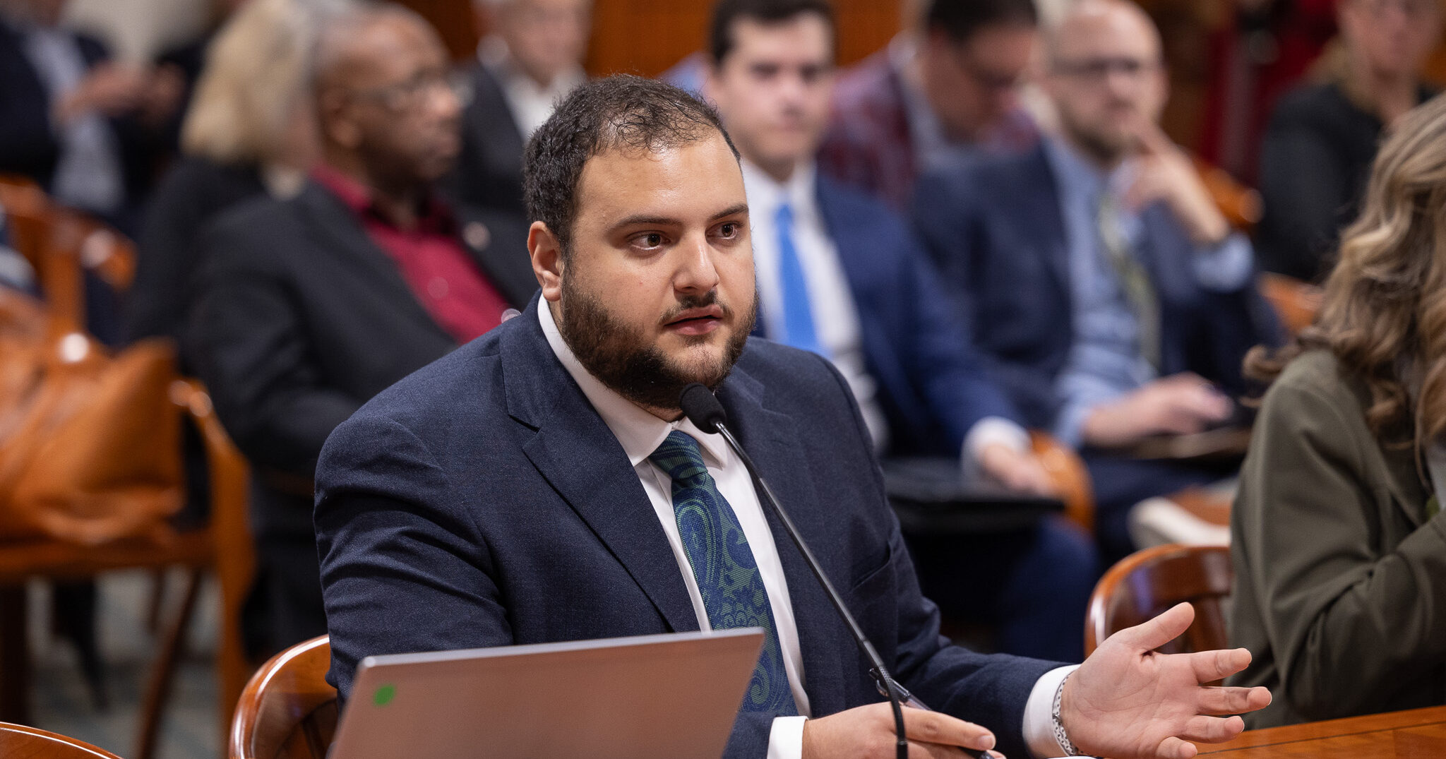 Michigan State Representative Alabas Farhat speaking at a committee meeting.