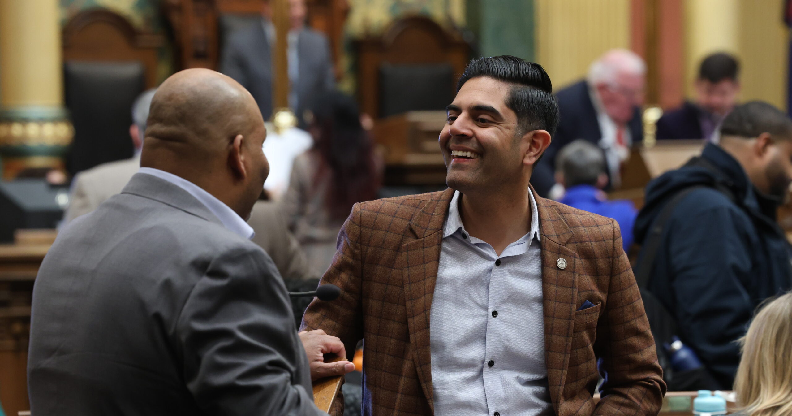 Democratic Leader Ranjeev Puri speaking with members on the House floor.