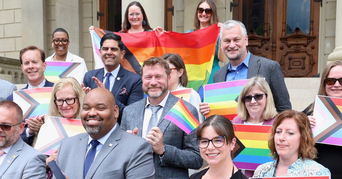 Members of the LGBTQ Caucus standing with their Democratic Colleagues for the Pride Month Resolution reading on Thursday, June 26, 2025, on the steps of the Capitol building in Lansing.
