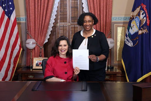 Sstate Rep. Stephanie A. Young and the governor, signing HB 4128.