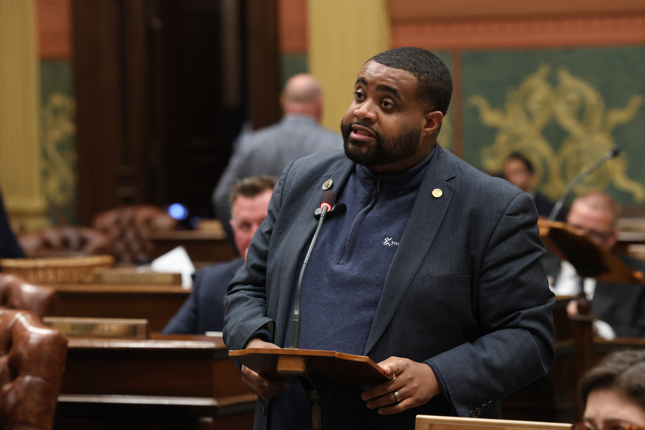 State Rep. Donavan McKinney speaking on the House floor at the Capitol building in Lansing.