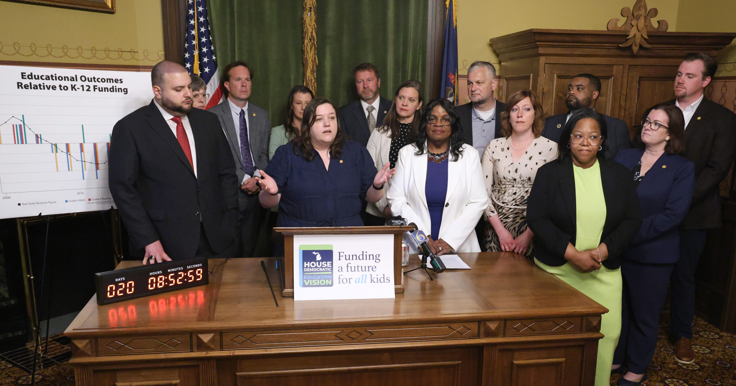 Michigan state Representatives Regina Weiss, Matt Koleszar and Carol Glanville standing alongside other Michigan House Democrats at their "Funding a Future for All Kids" press conference in the Michigan Capitol Building.