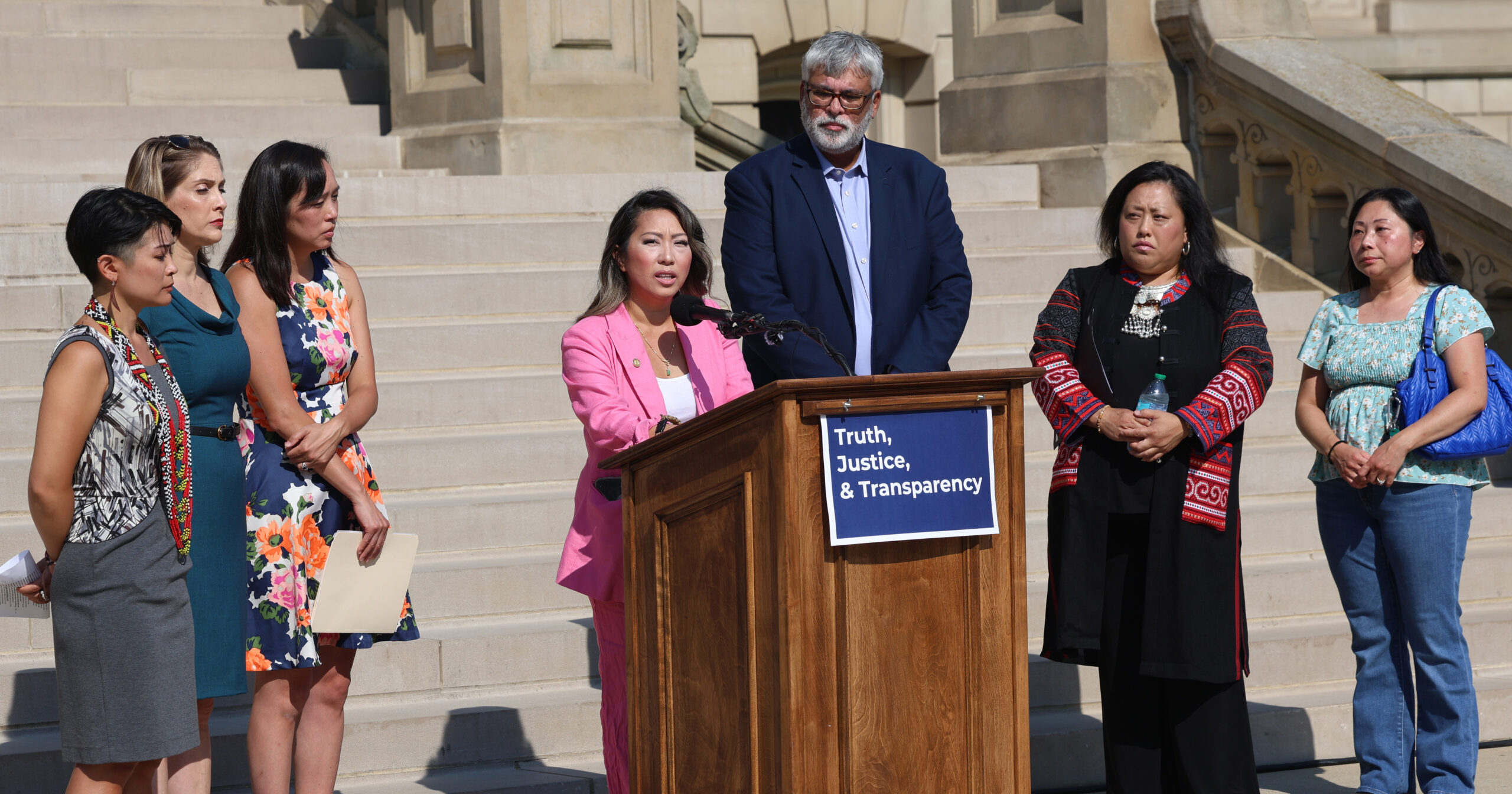 Michigan state Representative Mai Xiong speaking at a press conference on the front steps of the Michigan Capitol Building.