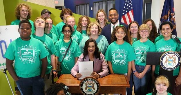 Michigan state Representative Reggie Miller, Michigan Governor Gretchen Whitmer and constituents attending the signing of Miller's 4-H license plate legislation.