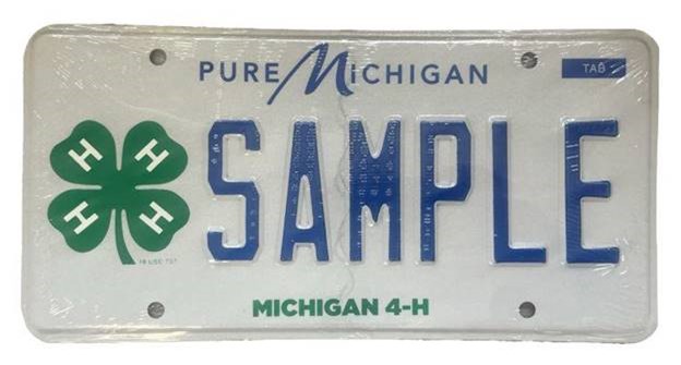 A sample Michigan license plate featuring a green clover with the letter H in each leaf. Across the top reads "Pure Michigan." Across the bottom reads "Michigan 4-H"