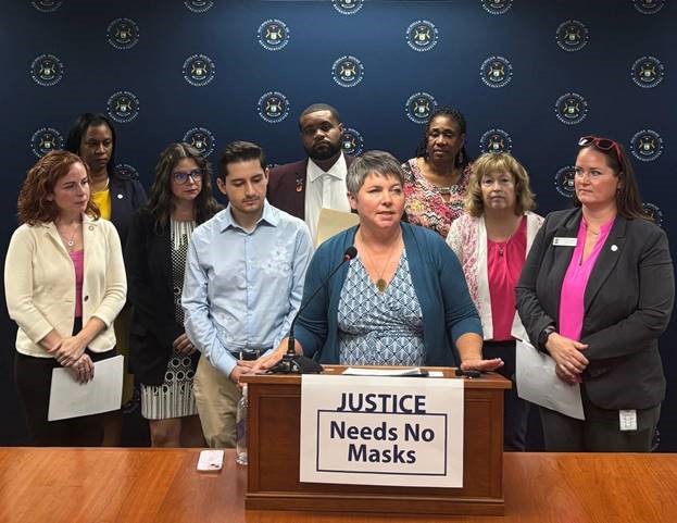 Michigan state Representative Betsy Coffia and members of the House Democratic Caucus speaking at the Justice Needs No Mask press conference.