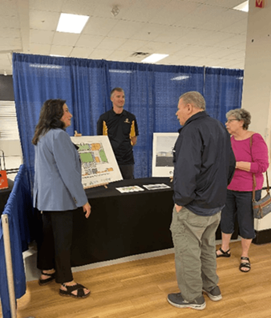 Michigan state Representative Angela Witwer speaking with community members at her Senior Healthy Aging Fair event.