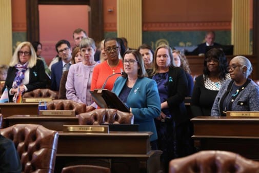 State Rep. Price (center) delivers a resolution on ovarian cancer awareness alongside her Democratic colleagues.