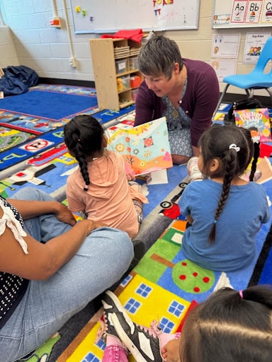 State Rep. Betsy Coffia reading to Northwest Education Services students.