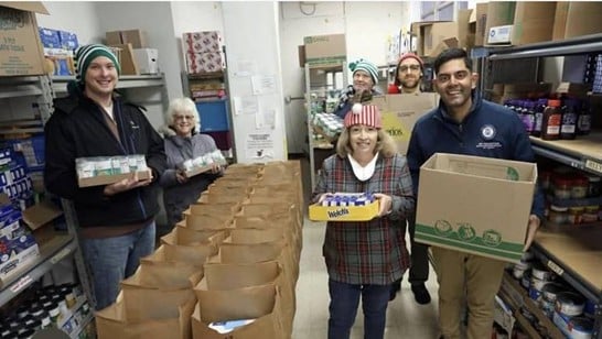 Democratic Leader Puri poses for a picture while helping deliver food