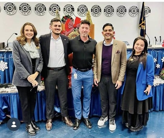 Democratic Leader Puri poses for a photo at a UAW event