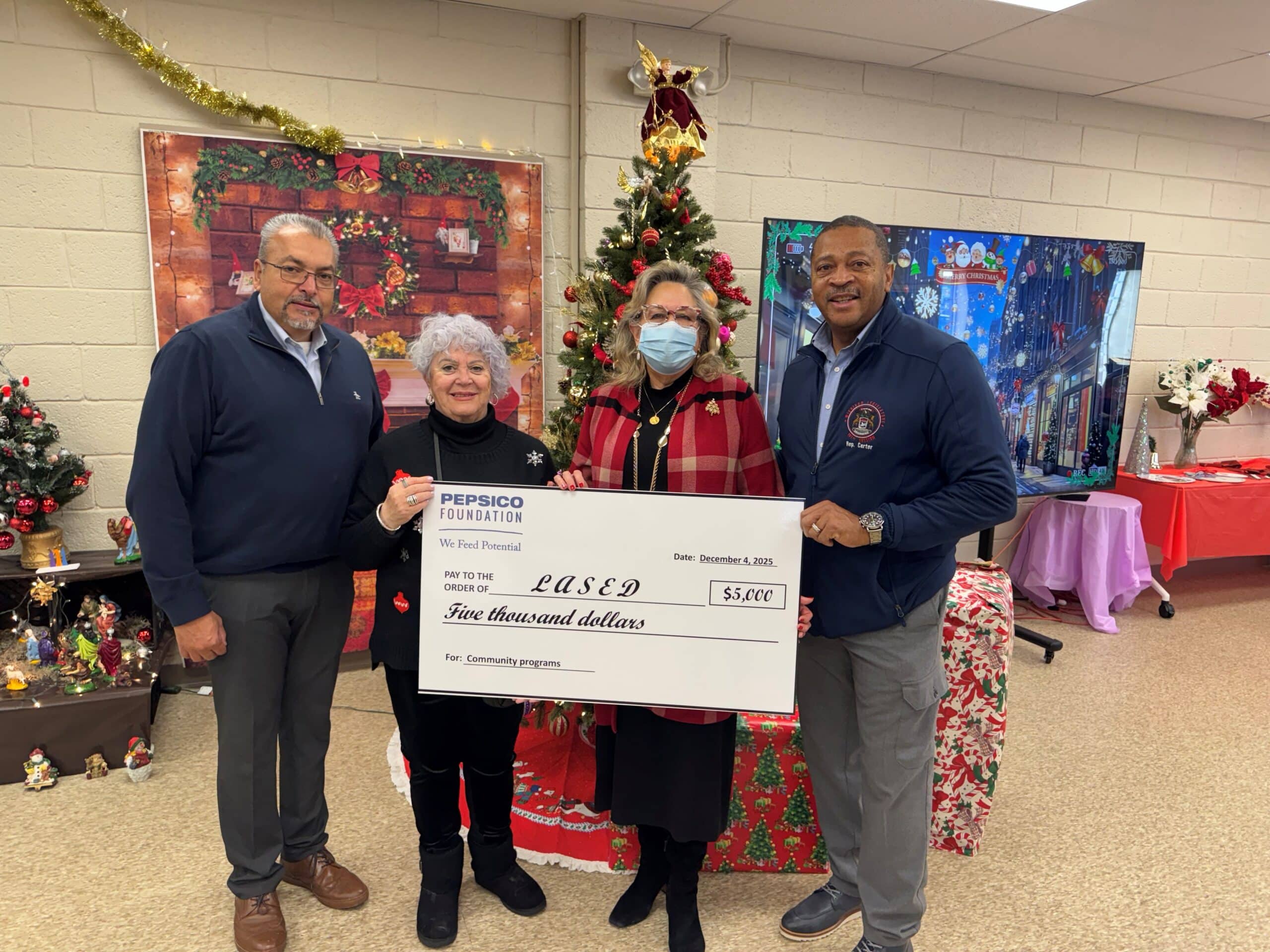 State Rep. Tyrone Carter presents a ceremonial check with representatives from the Pepsico foundation