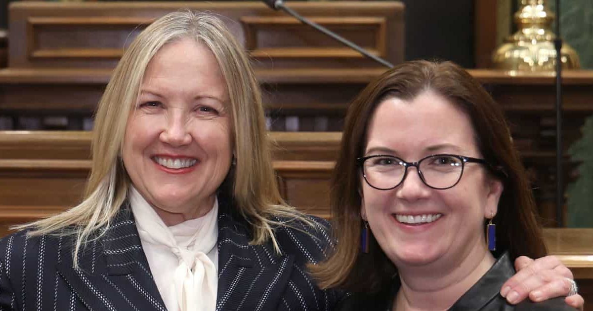 State Rep. Natalie Price (D-Berkley) standing with guest Deborah Wahl at the State of the State address on Wednesday, Feb. 25, 2026 on the House Floor at the Capitol Building in Lansing.