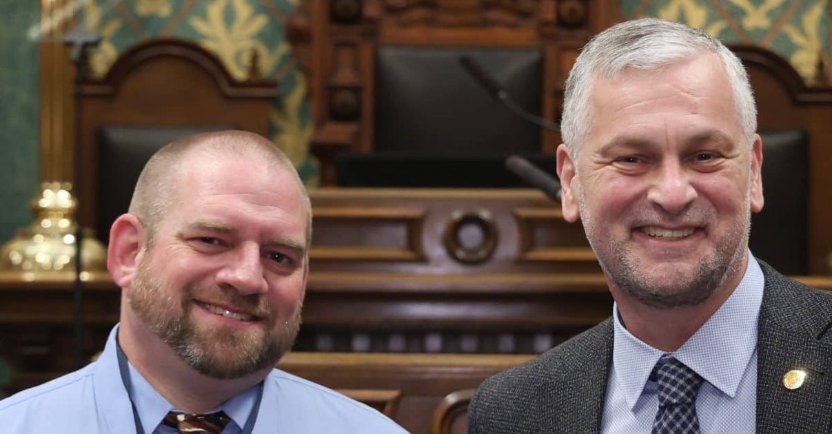 State Rep. Phil Skaggs standing with guest Justin Robbins, East Kentwood teacher and coach of the We the People team, at the State of the State address on Wednesday, Feb. 25, 2026 on the House Floor at the Capitol Building in Lansing.