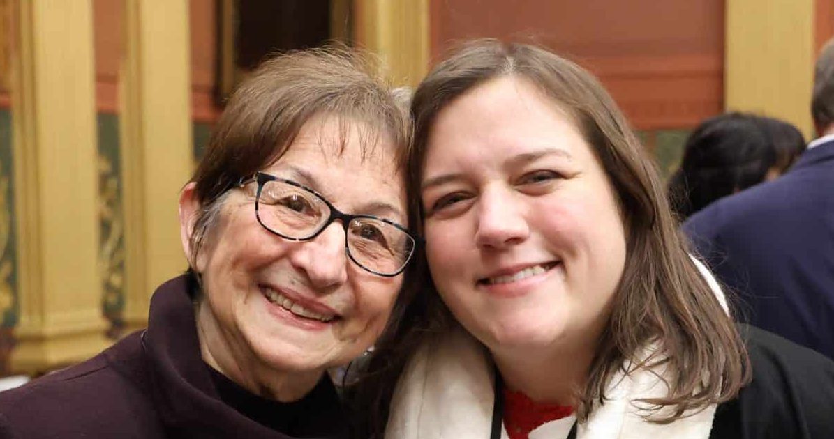 State Rep. Regina Weiss standing with guest Marian McClellan, Mayor of Oak Park, at the State of the State address on Wednesday, Feb. 25, 2026 on the House Floor at the Capitol Building in Lansing.