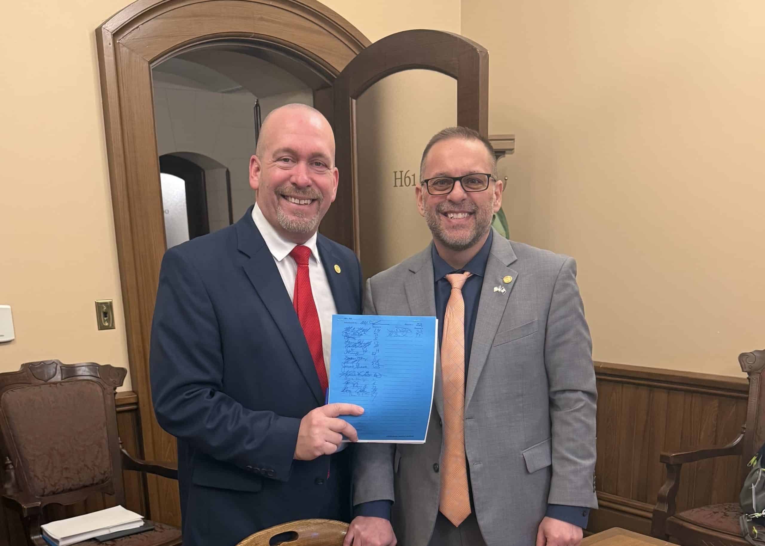 State Reps Mike McFall (D-Hazel Park) and Mike Harris (R-Waterford) standing together after introducing House Bills 5705 and 5706 on Thursday, March 5, 2026, at the Capitol Building in Lansing.