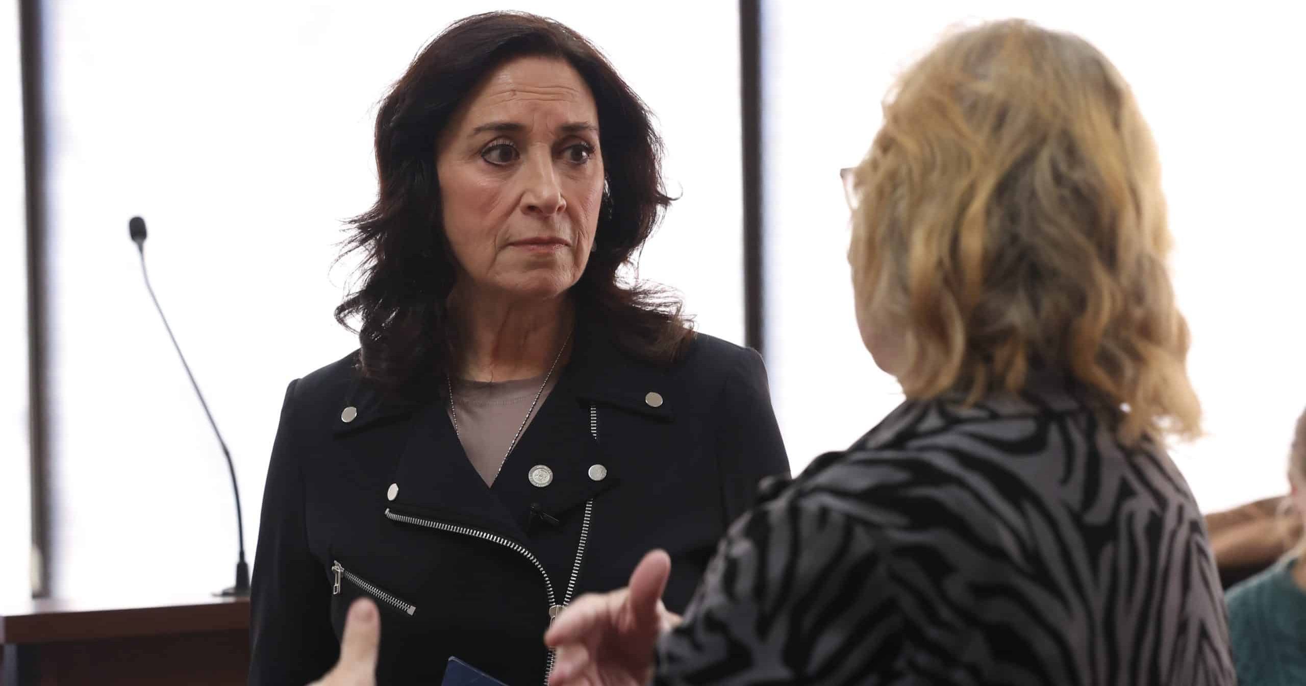 State Rep. Angela Witwer listens to a constituent in the community
