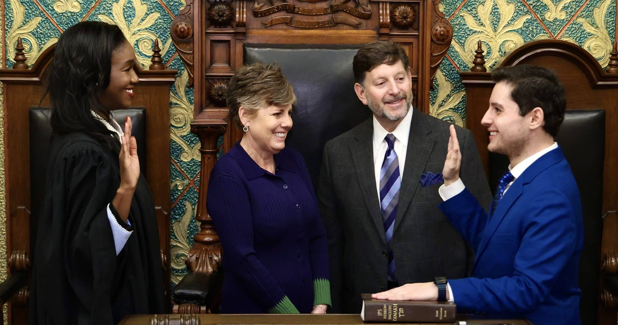 State Representative Noah Arbit being sworn in by Michigan Supreme Court Justice Kyra Bolden Harris on the House floor.