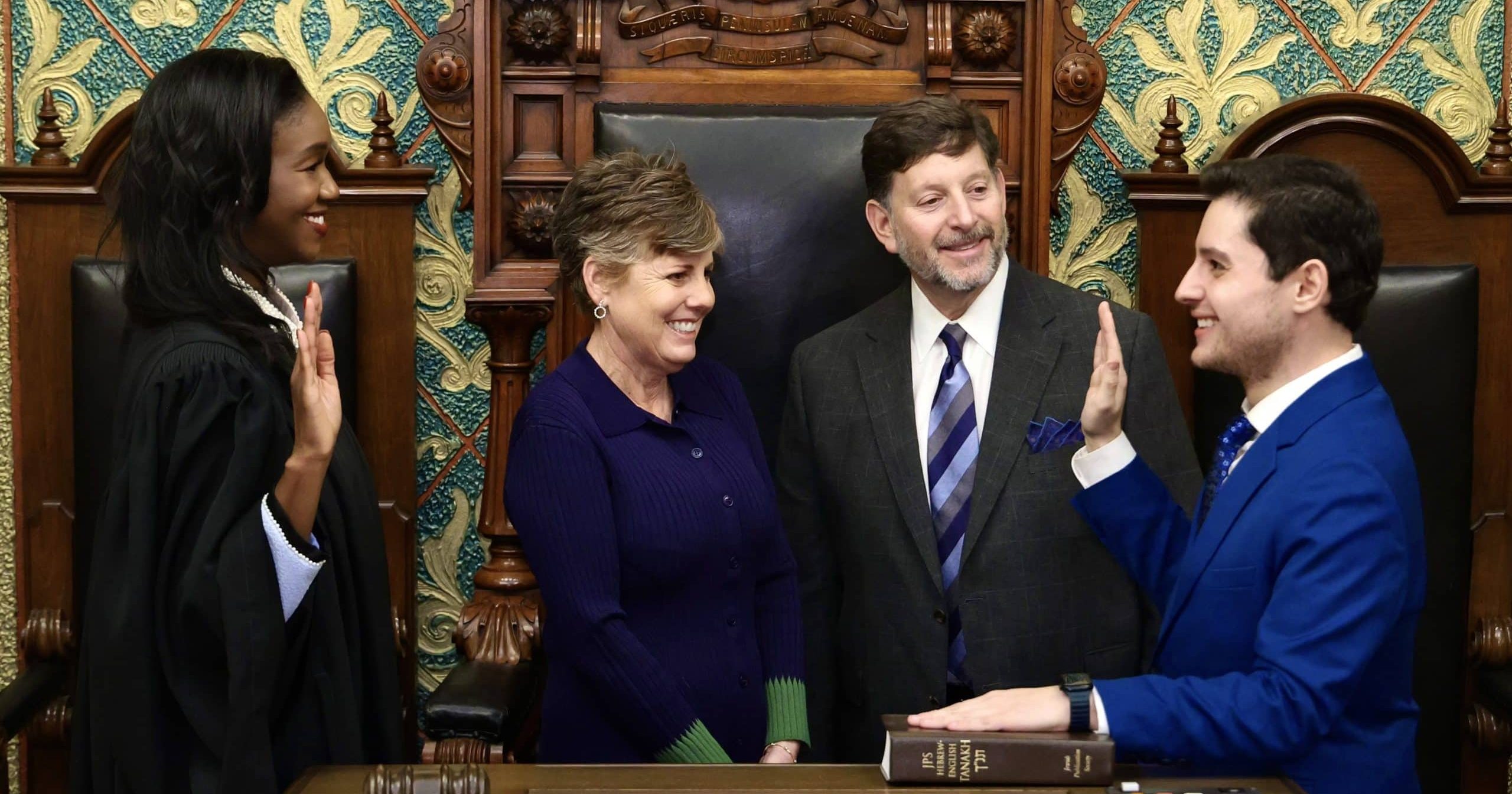 State Representative Noah Arbit being sworn in by Michigan Supreme Court Justice Kyra Bolden Harris on the House floor.